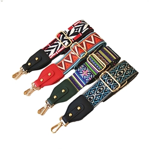 Detail of four ethnic pattern woven bag straps with gold metal hooks and leather ends