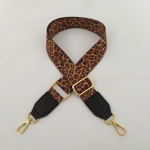 Detailed view of leopard print wide replacement bag strap with gold metal hooks and adjusters