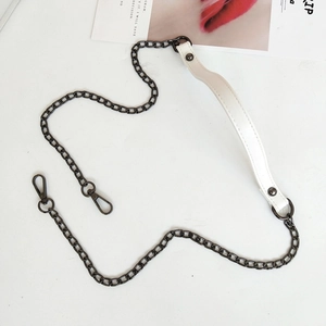 Close-up of white PU leather shoulder pad and dark grey metal chain with spring hooks