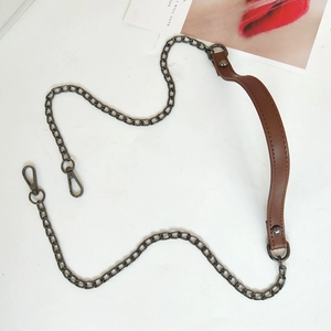 Detail of dark gunmetal chain with brown PU leather shoulder pad and lobster clasps