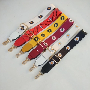 Close-up of colorful adjustable replacement guitar-style bag straps with daisy patterns