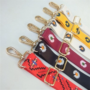 Close-up of colorful ethnic daisy patterned replacement straps with gold metal hooks