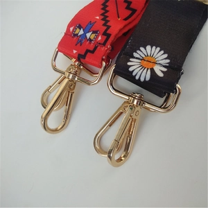 Close-up of ethnic geometric and daisy pattern straps with gold metal lobster clasps