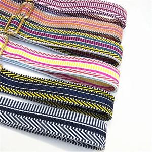 Close-up of adjustable woven shoulder straps with colorful patterns and gold metal buckles