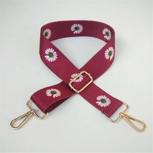 Detail view of burgundy daisy floral replacement strap with gold metal lobster clasps
