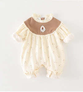 Detail of baby floral romper featuring a vintage brown collar and lace-trimmed edges