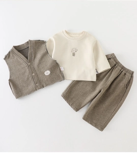 Detailed flat lay of toddler 3-piece knit set featuring brown vest and animal print top
