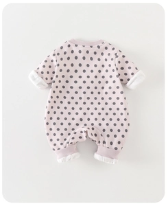Detail of pink long-sleeve baby romper with gray polka dots and ribbed cuffs