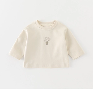 Detailed view of cream-colored baby sweatshirt with soft ribbed neck and cute bear prints