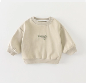 Detail view of cotton beige toddler sweatshirt with YooSt embroidery and ribbed collar