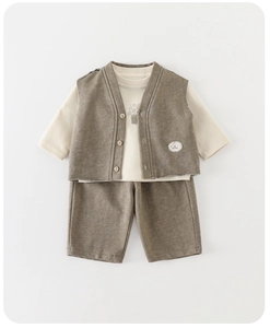 Flat lay of baby boy three-piece suit with brown vest, long sleeve shirt and shorts