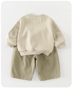 Detail of baby autumn sweatshirt set with ribbed cuffs and embroidered patch design