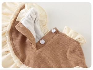 Detail of baby floral waffle jumpsuit showing ruffle collar and delicate button closure