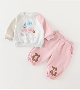 Detailed flat lay of toddler autumn cotton set with cartoon bear print and text
