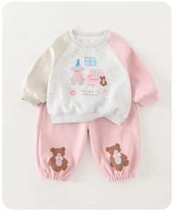 Detail of baby girl cotton tracksuit with cartoon prints and soft ribbed cuffs