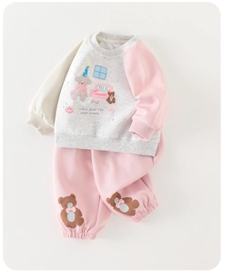 Detail of baby girl cotton tracksuit featuring cute cartoon bear prints and ribbed cuffs