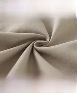 Detail of high-density knit fabric showing soft beige texture and breathable fiber quality