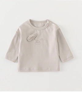 Détail d'un t-shirt bébé en coton avec boutons pressions et broderie hérisson