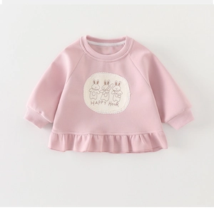 Detail of pink girls' sweatshirt featuring ruffled hem and rabbit patch embroidery decoration