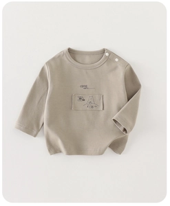 Detail of baby cotton long sleeve shirt with coffee print and shoulder snap buttons