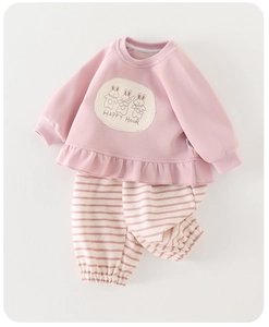 Detail view of pink girls sweatshirt with rabbit embroidery and striped cotton pants