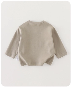 Back view of a long-sleeve cotton baby t-shirt in khaki with detailed laundry label