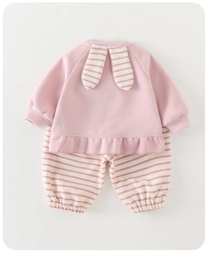 Detail of pink cotton baby sweatshirt with rabbit ear decor and striped trousers