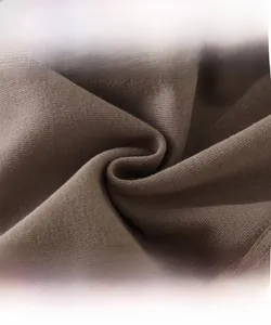 Close-up of thick coffee brown knit fabric with cotton flower showing soft texture