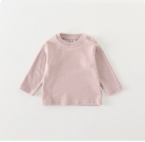 Detail of baby girl's pink long sleeve cotton T-shirt with shoulder snap buttons for easy wear