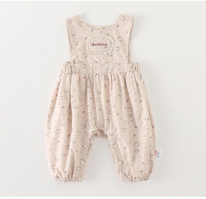 Detailed macro view of baby floral cotton suspender suit with delicate lace embroidery