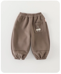 Detail of mocha brown kids jogger pants featuring elastic waistband and cartoon cat back pocket