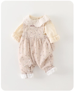 Close-up of baby floral jumpsuit with lace collar and sunshine embroidery detail