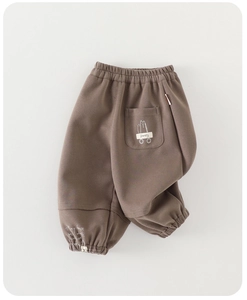 Detail of dark brown kids jogger pants with happy cat pocket and elastic waist