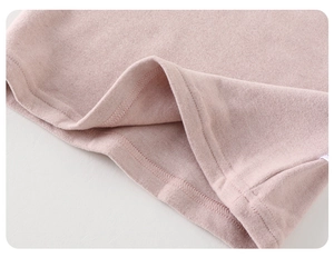Close-up of soft pink brushed fleece fabric with durable double-needle stitching details