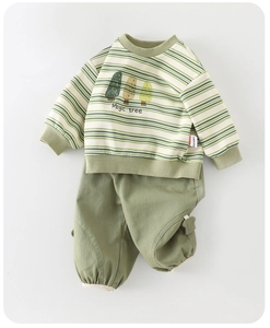 Flat lay detail of green striped baby sweatshirt with Magic tree print and matching pants