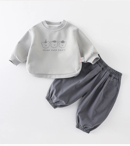 Detail view of baby boy cotton sweatshirt set featuring cartoon bears and elastic cuffs