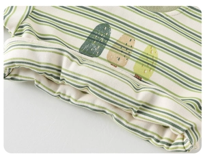 Detail of baby striped knit top showing ribbed fabric and tree prints in green and yellow