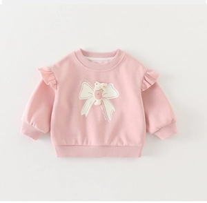Pink toddler girls sweatshirt with ruffled shoulders, rabbit doll, and white bow print