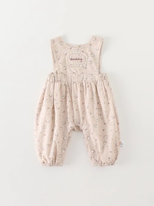 Pink floral infant romper with sunshine embroidery and lace trim on white background
