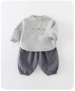 Detail of the soft cotton fabric and cute cartoon bears print on the baby boy sweatshirt