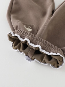 Kids brown knit jogger pants featuring elastic waist with ruffle trim and bike print