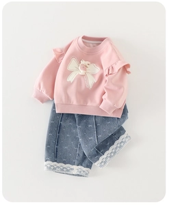 Detail of pink sweatshirt with 3D bunny doll and lace-trimmed bow pattern denim jeans