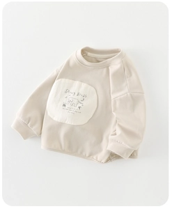 Close-up detail of soft beige cotton sweatshirt with elephant pocket and poetry text
