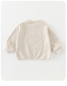 Back view of cream long-sleeve kids sweatshirt showing soft knit cotton and ribbed cuffs