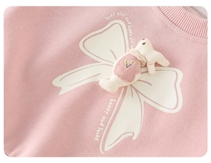 Detail of pink girls sweater with 3D plush rabbit doll and daisy embroidery detail
