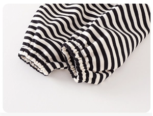 Macro detail of elastic ribbed cuffs on black and white striped cotton baby suit