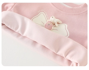 Detail of pink toddler sweatshirt featuring a plush 3D bunny and white bow print