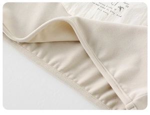 Close-up of ribbed knit fabric hem with printed artistic poem patch for boys shirt