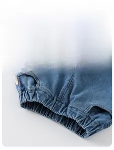 Dettaglio dei pantaloni in denim blu da bambina con vita elastica e tasche