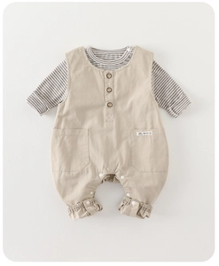 Detail of baby cotton overall set with wooden buttons and striped long sleeve top